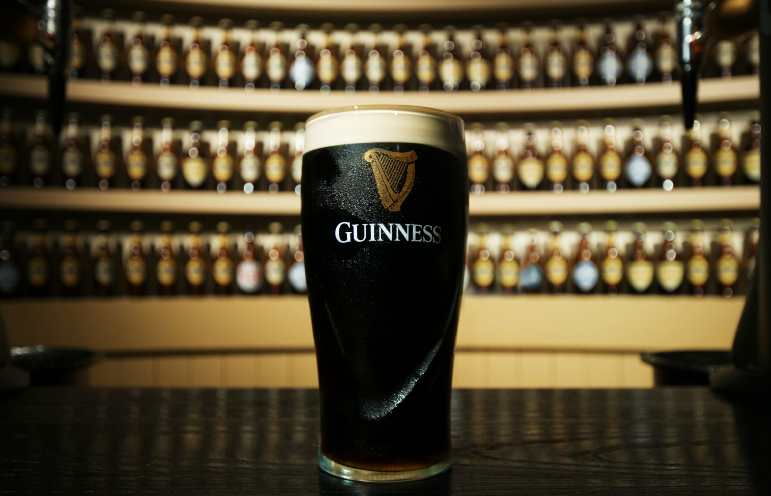 Glass of Guinness with foam onto